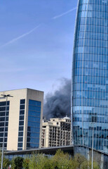 Fototapeta premium black smoke from burning building in the distance