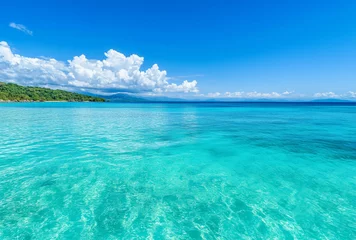 Gordijnen  turquoise ocean water and blue sky with white clouds © Kritchanok