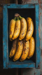 Fresh bananas in a weathered wooden crate