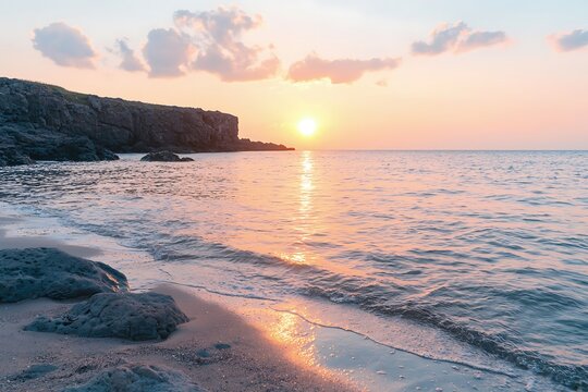 Pink Sunset Over Rocky Shore with Gentle Waves