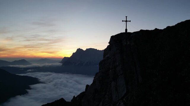Aerial shot of mountain Zugspitze, revealing from behind Grubigstein at sunrise
