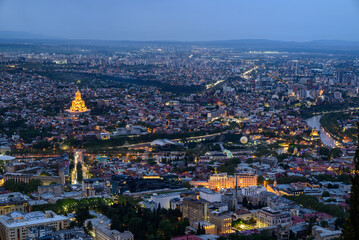 Cityscape of Tbilisi, Georgia, aerial panoramic night view from Mtatsminda Park hill