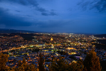 Cityscape of Tbilisi, Georgia, aerial panoramic night view from Mtatsminda Park hill