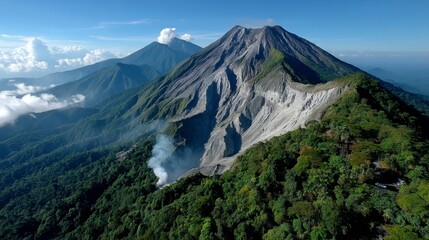 Naklejka premium Volcanic landscape with lush green slopes and a rocky summit under a bright sky. A hint of smoke rises from the crater.