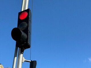 French traffic light at red against blue sky with copy space