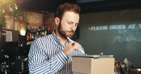 Restaurant, boxes and man on tablet in cafe for menu items, inventory and order checklist at bar. Pub, hospitality and business owner on digital tech for internet, planning and review on website