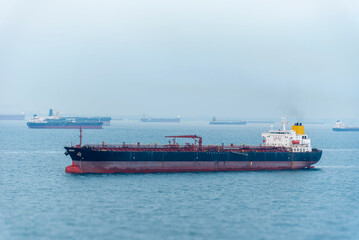 Tanker ship departing from port of Singapore. She is beginning voyage on her international trade...