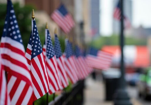 A line of american flags waves gently in the wind, patriotic display on the street.