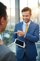 Engaging business discussion between two professionals in a modern office during golden hour