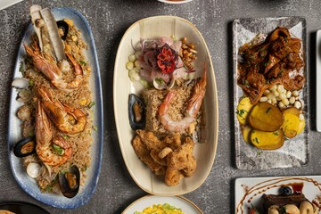 Assorted seafood dishes elegantly presented on plates.