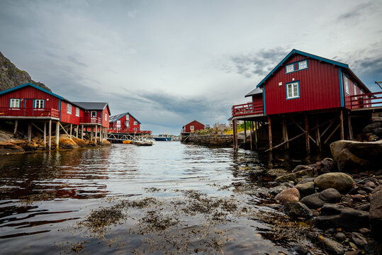 Experience the Charming Red Cabins by the Water within Norways Abundant Scenic Landscape