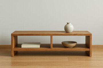 low japanese wood cabinet with open shelves, book, bowl and ceramic vase on wooden floor