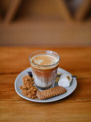 Coffee. A morning drink : dirty coffee served with burned marshmallow and biscuit on wooden table with copy space for your text.