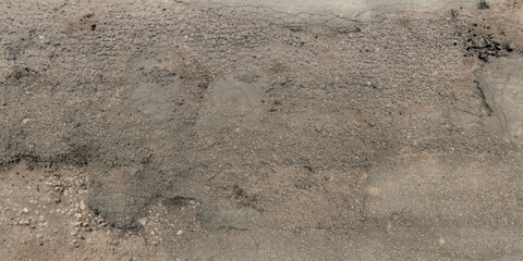view from above on texture of asphalt road surface with cracks