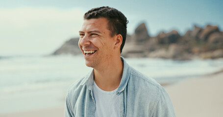 Thinking, laughing and man at sea for holiday, vacation and outdoor travel for adventure. Beach, funny joke and happy person in nature at ocean for trip, summer and tourism ideas on island in Spain