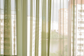 Green tulle, close-up, hung above the window.