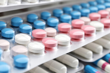 Colorful assortment of medications displayed on a shelf creates a chaotic visual experience