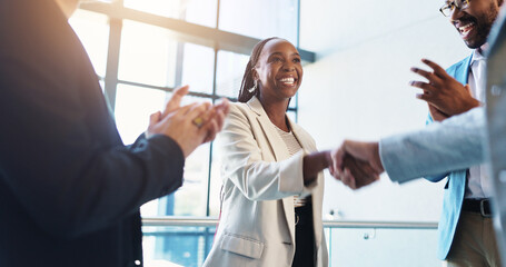 Office, handshake and business people with applause for success, congratulations and celebration. Corporate, professional and men and women shaking hands for job promotion, achievement and onboarding