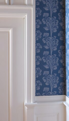 Fototapeta premium White wood trim and blue wallpaper, detailed. White tone