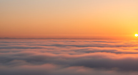 Fototapeta premium Sunrise Over Clouds with Orange Sky and Hazy Horizon