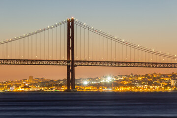 25th of April Suspension Bridge and Tagus River at Evening Twilight. Lisbon, Portugal. Blue Hour. View from Cacilhas