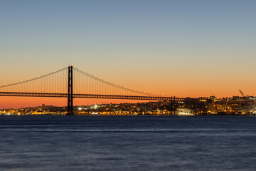 25th of April Suspension Bridge and Tagus River at Evening Twilight. Lisbon, Portugal. Blue Hour