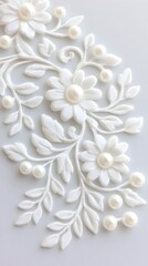 Elegant white floral design with pearl accents, embossed on a light grey background