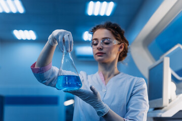 American Female medical scientist in goggles holding chemical liquid into test tube analysis. Advanced Scientific Lab for Pharmaceutical Medicine, Biotechnology. Vaccine solution concept. Ads
