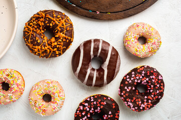 Set of various colorful donuts on white background. Top view.