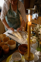 Grandmother with preparing traditional easter meals, baking cakes and sweets. Passing down family recipes, custom and stories. The woman is getting ready at home