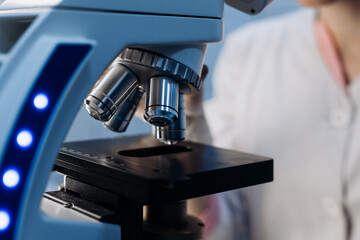 Scientist using microscope in laboratory, making medical testing and research, close-up....