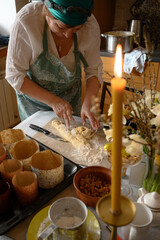 Grandmother with preparing traditional easter meals, baking cakes and sweets. Passing down family...