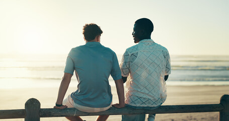 Back, beach and men with vacation, friends and conversation with tropical island. People, ocean and travel with summer holiday, weekend break and bonding together with discussion, sunset and seaside