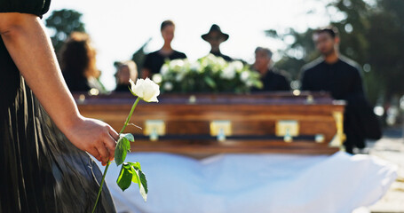 Hand, rose and woman at graveyard for funeral ceremony, grief and memorial service outdoor with...