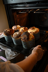 Easter cakes are baked in the oven. I take homemade Easter bread out of the oven. Happy Easter!	