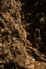 Stone background, stone wall with rough texture. Abstract, rough and textured surface of stone material. Details of the nature of rocks.
