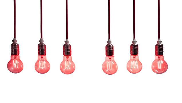 Illuminated red light bulbs hanging from cords against a dark transparent background in a studio setting png