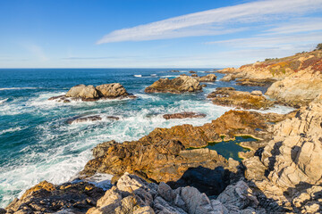 Stunning coastal landscape along California's Highway 1, featuring rugged rocky formations, and the vast blue ocean. A breathtaking natural scene showcasing the raw beauty of the Pacific coastline