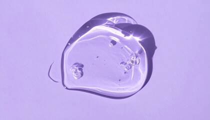 Fototapeta premium Transparent hyaluronic acid, gel or serum smear texture on purple backdrop. Moisturizing, skin care