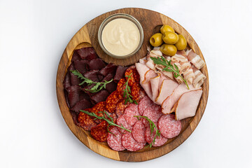 Wooden plate with sausages, ham, salami 