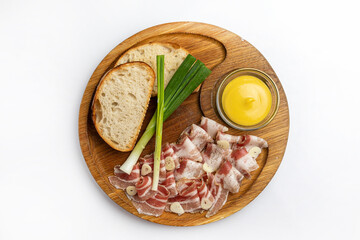 Slices of prosciutto ham on a wooden board