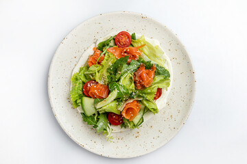salad with salmon and cherry tomatoes on a white background in the restaurant