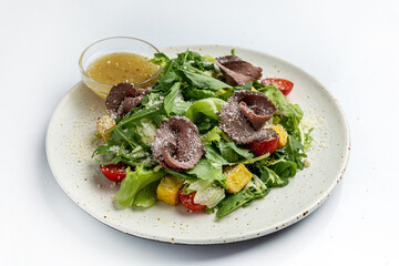 salad with beef tongue and vegetables on a white background in the restaurant