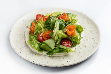 salad with salmon and cherry tomatoes on a white background in the restaurant