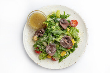 salad with beef tongue and vegetables on a white background in the restaurant