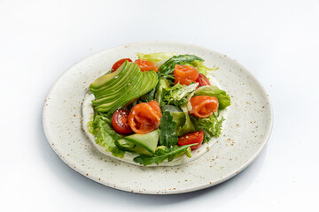 salad with salmon and cherry tomatoes on a white background in the restaurant
