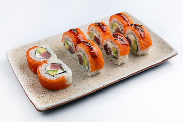 Sushi roll with salmon, avocado and cucumber on white background