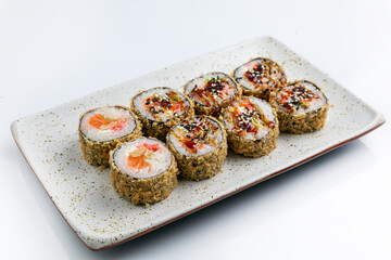 Sushi roll with salmon, avocado and cucumber on white background