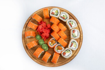 Sushi roll with salmon, avocado and cucumber on white background