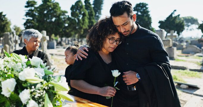 Hug, grief and funeral with people, graveyard or empathy with emotion, mental health or comfort. Ceremony, outdoor or family with loss, support or sad with compassion, mourning or embrace with burial
